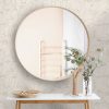 Big,Round,Mirror,,Table,With,Jewelry,And,Decor,Near,Brick