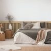 Flowers,On,Wooden,Stool,And,Pouf,In,White,Bedroom,Interior